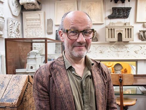 Paul Noble stands in the Drawing Office at Sir John Soane's Museum.